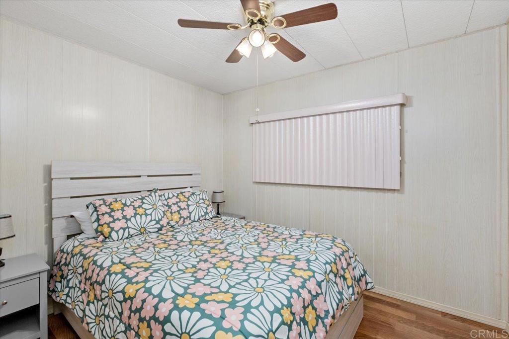 28890 Lilac Road, Unit 80 Valley Center, CA 92082 - Photo 18 of 33 a bedroom with a bed and a chandelier