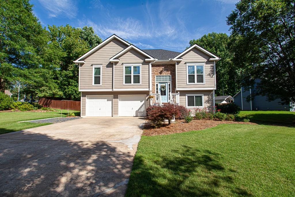 3815 Pheasant Run Trace Cumming, GA 30028 - Photo 1 of 1 a front view of a house with a yard and garage