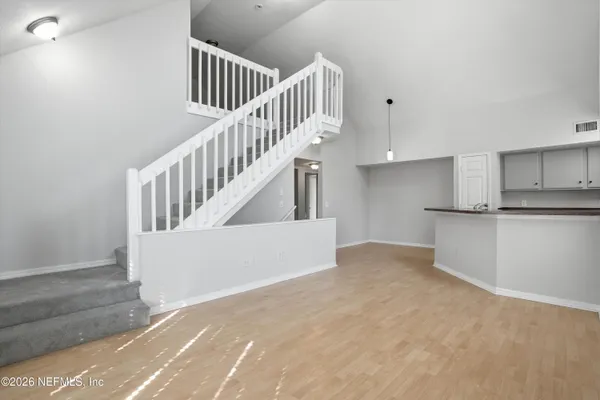 a view of staircase and kitchen with sink
