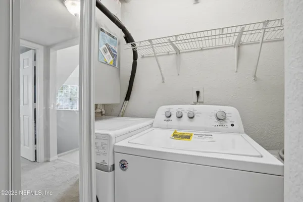 a bathroom with a sink and a refrigerator