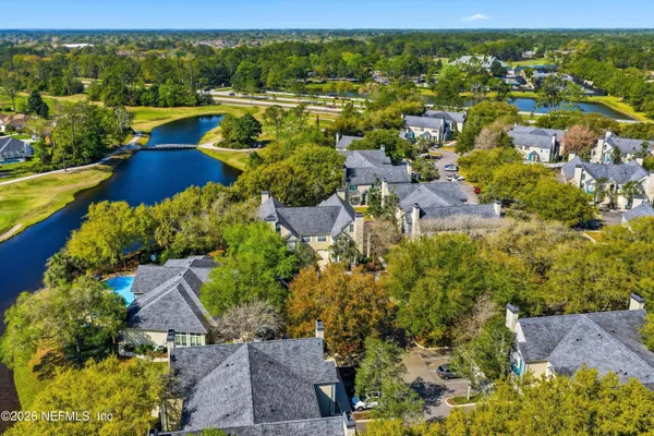 an aerial view of residential houses with outdoor space and street view