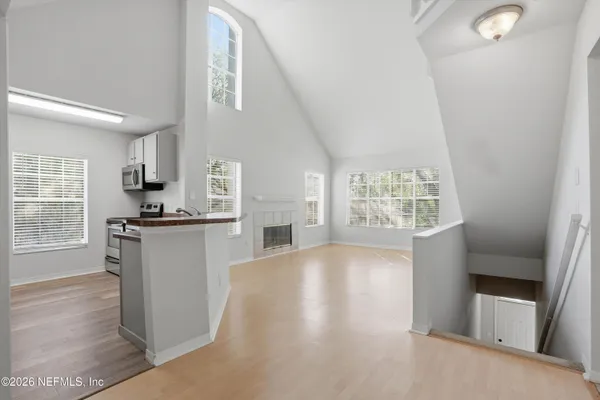 a kitchen with granite countertop a stove a sink and a refrigerator