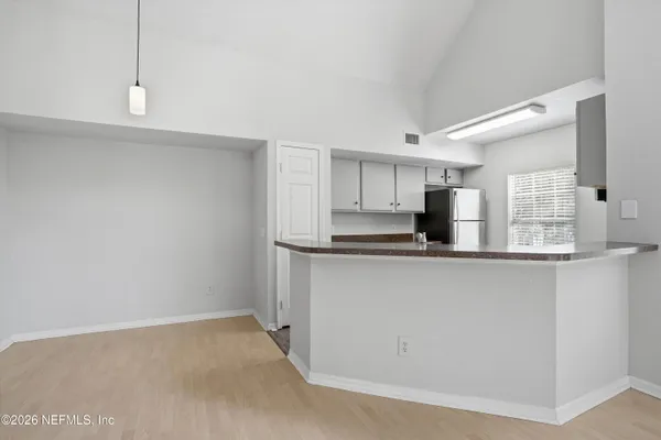 a kitchen with stainless steel appliances a refrigerator and window