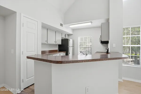 a kitchen with stainless steel appliances granite countertop a sink and a microwave