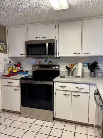 a kitchen with cabinets appliances and a sink