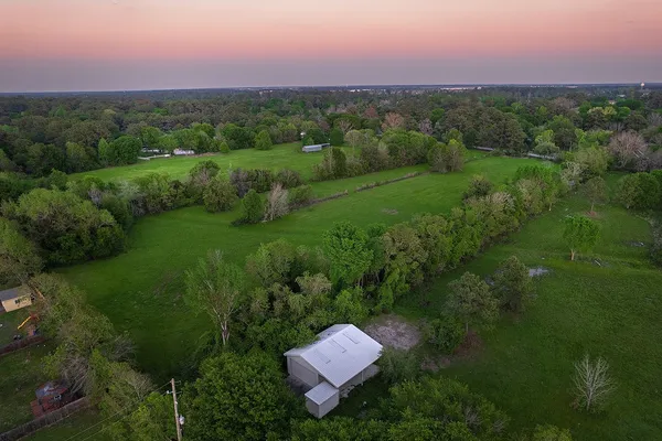 a view of a green field in front of the house