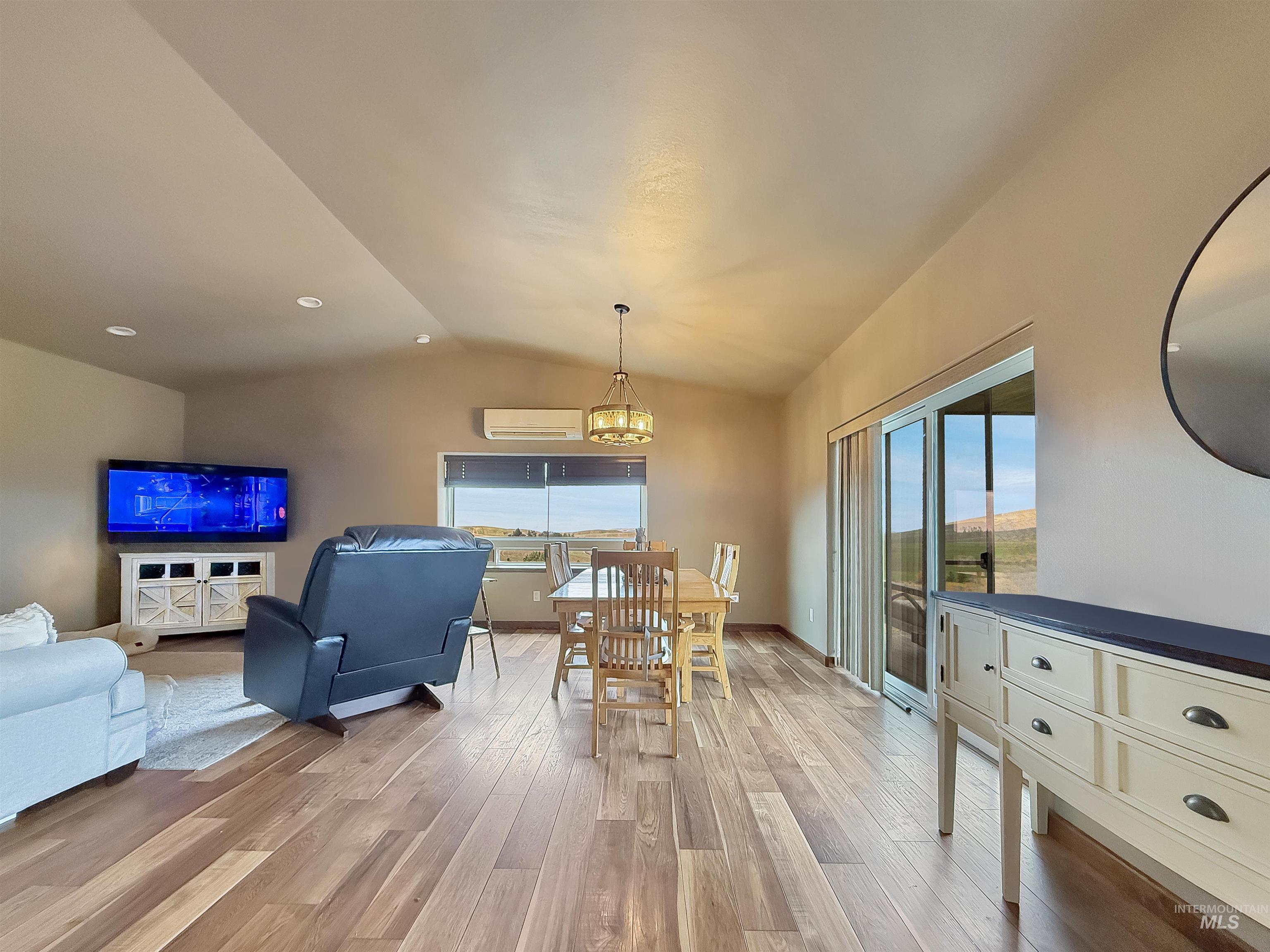 1030 Tempest Lane Viola, ID 83872 - Photo 11 of 37 Dining space featuring light wood-type flooring, plenty of natural light, and a chandelier