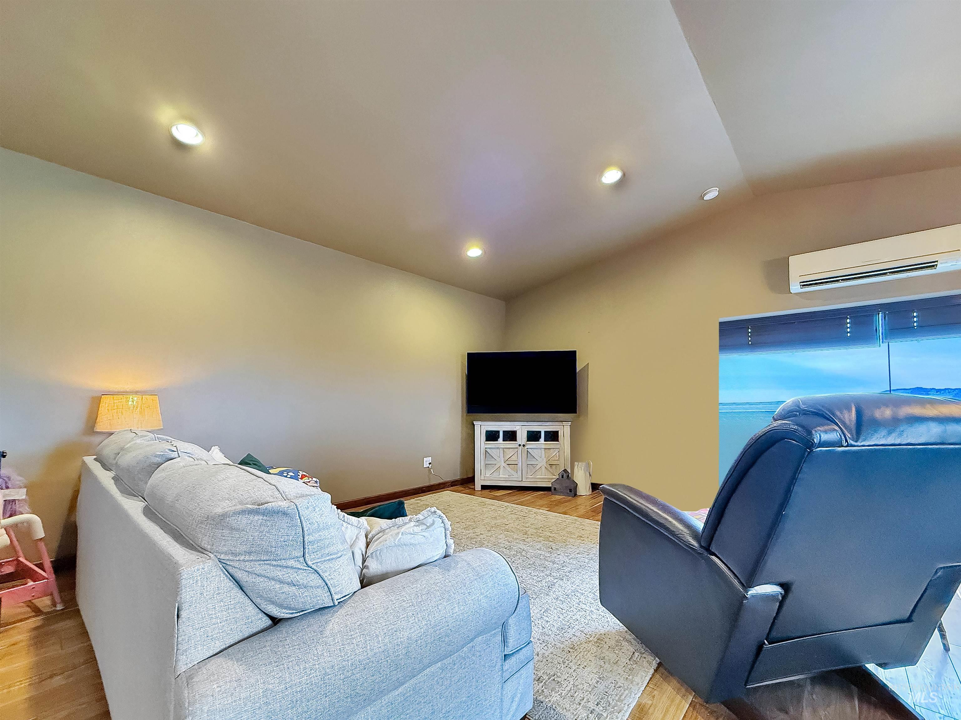 1030 Tempest Lane Viola, ID 83872 - Photo 12 of 37 Living room featuring vaulted ceiling, light wood-type flooring, and recessed lighting
