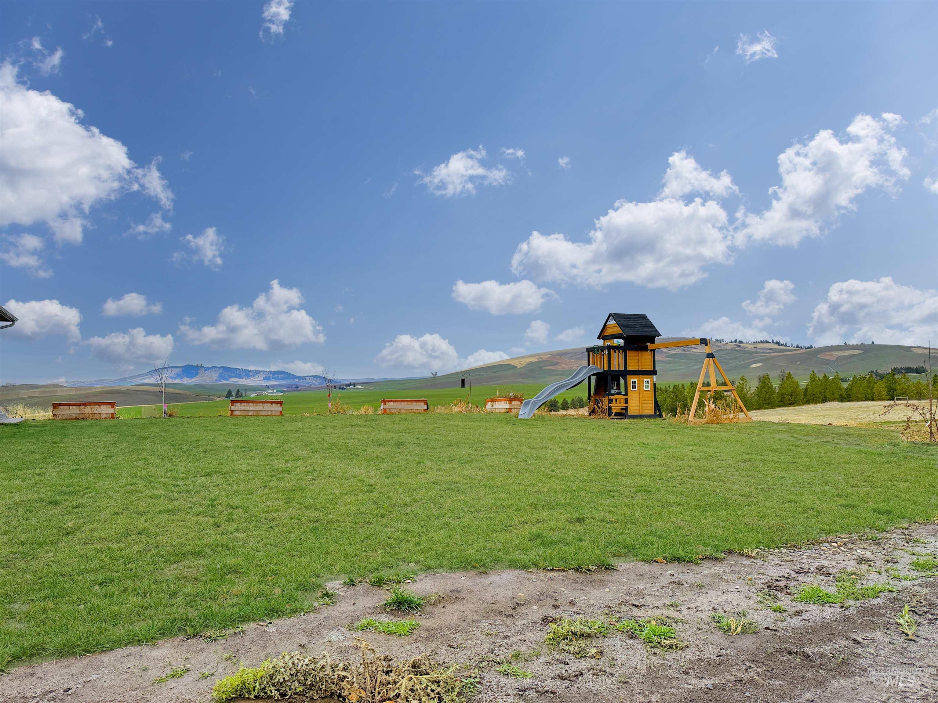 1030 Tempest Lane Viola, ID 83872 - Photo 30 of 37 View of play area featuring a view of rural / pastoral area, a yard, and a mountain view