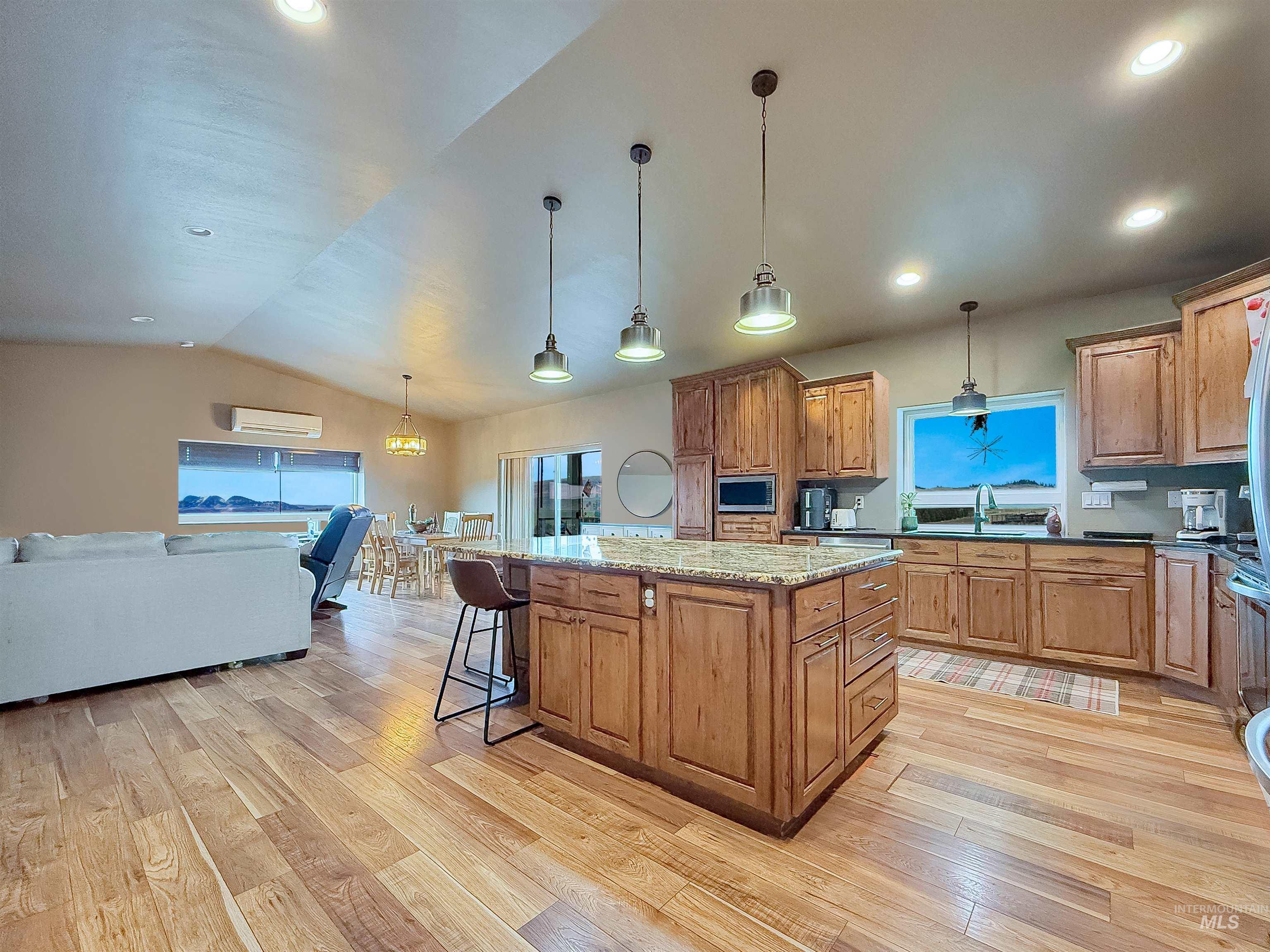 1030 Tempest Lane Viola, ID 83872 - Photo 5 of 37 Kitchen featuring wood finish cabinets, pendant lighting, a kitchen island, a breakfast bar area, and lofted ceiling