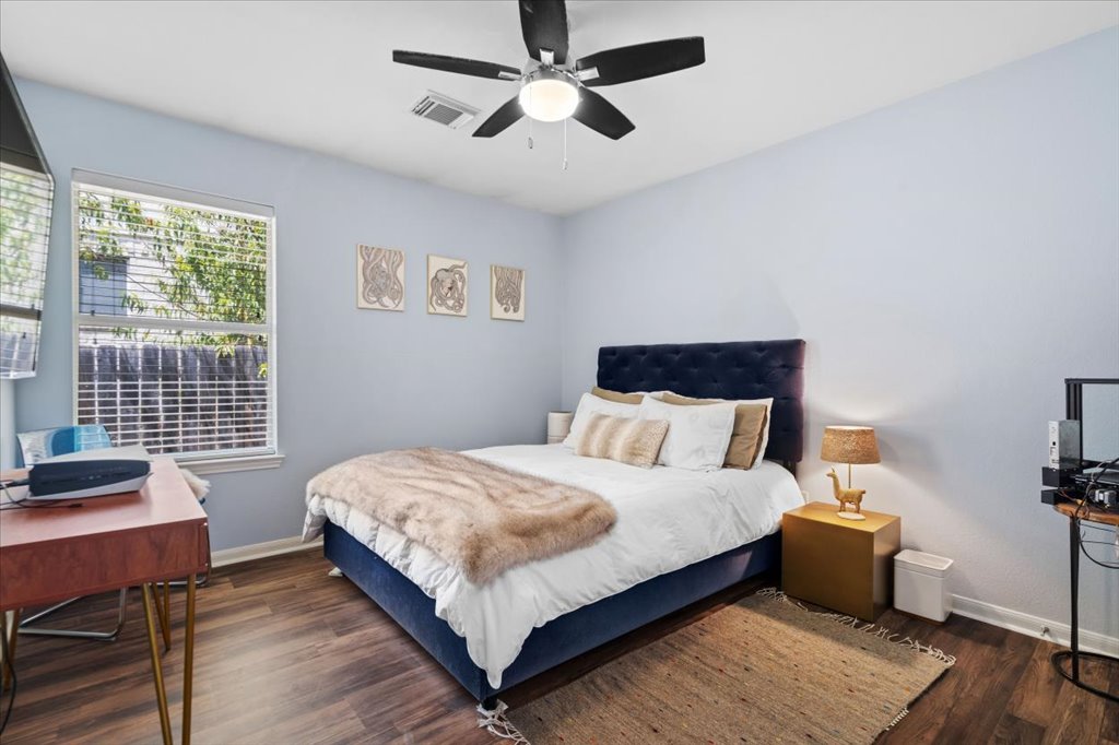13200 Calf Roping Trail Austin, TX 78727 - Photo 22 of 28 Rich wood-inspired floors and a wide window create a comfortable, inviting atmosphere.