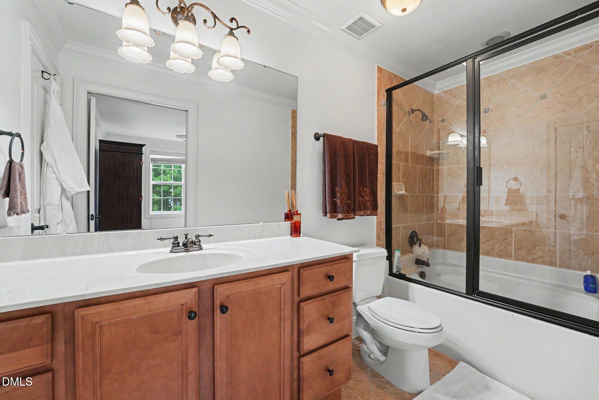 1729 Frenchwood Drive Raleigh, NC 27612 - Photo 32 of 46 a bathroom with a sink a toilet and a large mirror