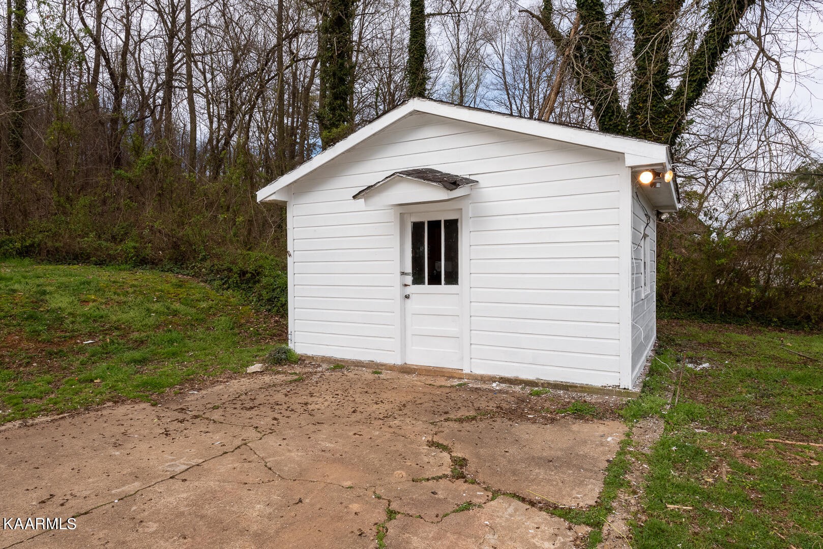 1399 Niles Ferry Road Greenback, TN 37742 - Photo 27 of 28 a white house that has a small yard and large trees