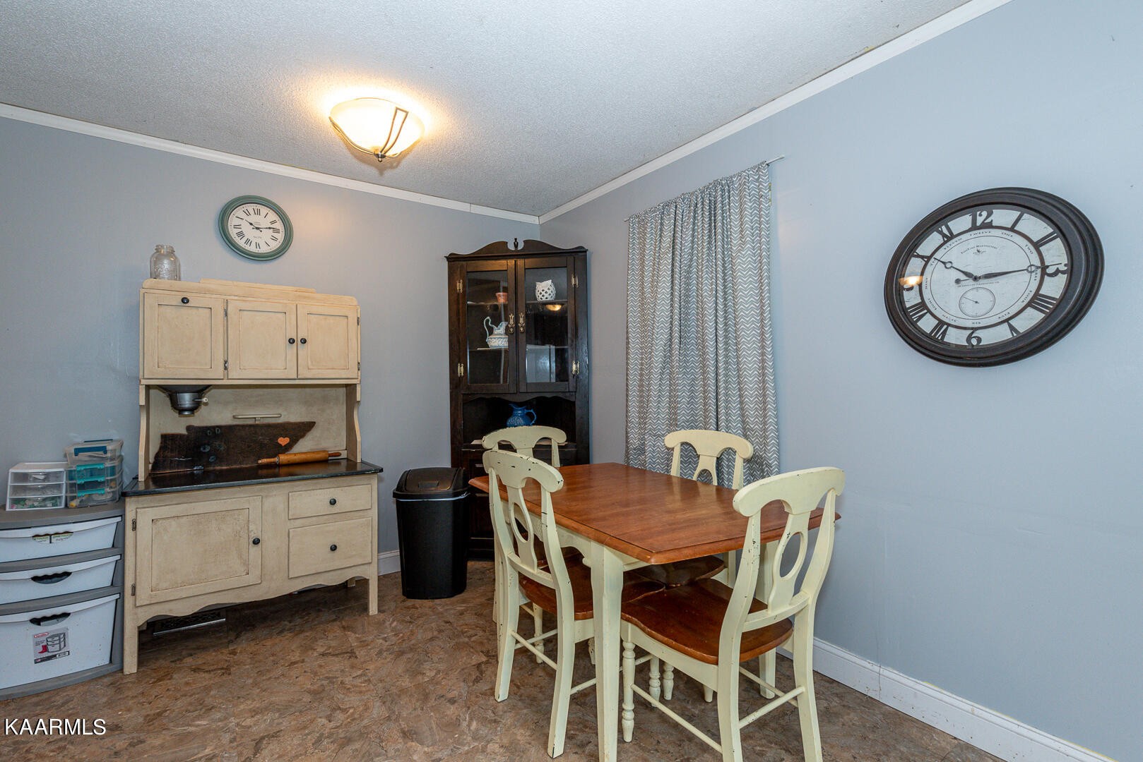 1399 Niles Ferry Road Greenback, TN 37742 - Photo 6 of 28 a dining room with furniture and a clock on the wall