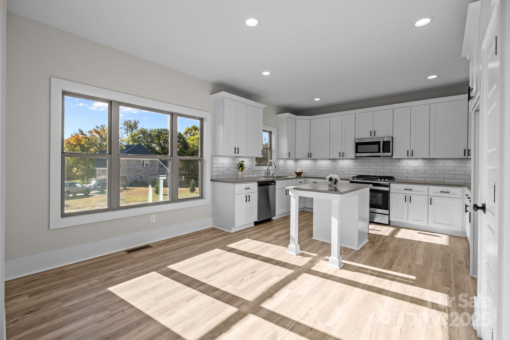 2003 Duntov Drive Monroe, NC 28110 - Photo 13 of 44 a kitchen with a stove a sink and a refrigerator