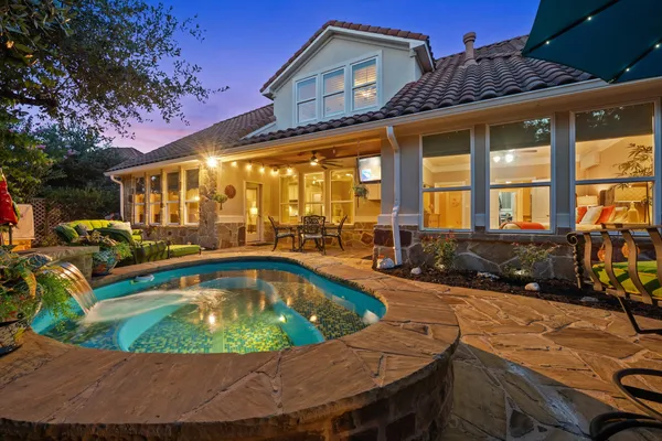 a view of a house with swimming pool and sitting area