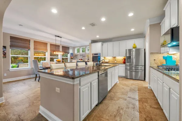 a kitchen with stainless steel appliances granite countertop a stove and a sink