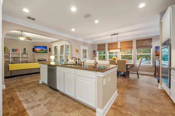 a kitchen with sink and view of living room