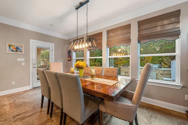 a view of a dining room with furniture window and outside view