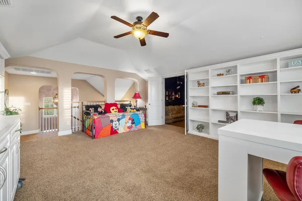 a view of game room with racks and white cabinet