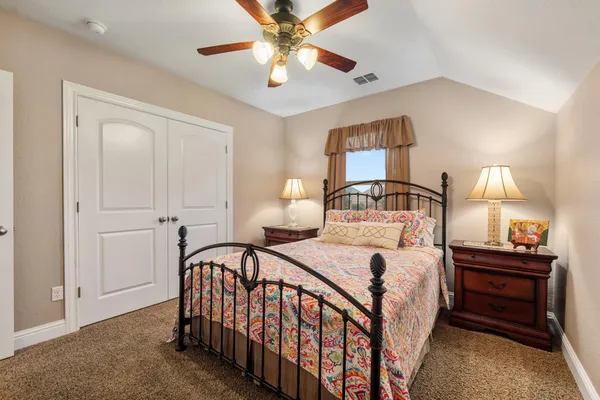 a bedroom with a bed and a chandelier