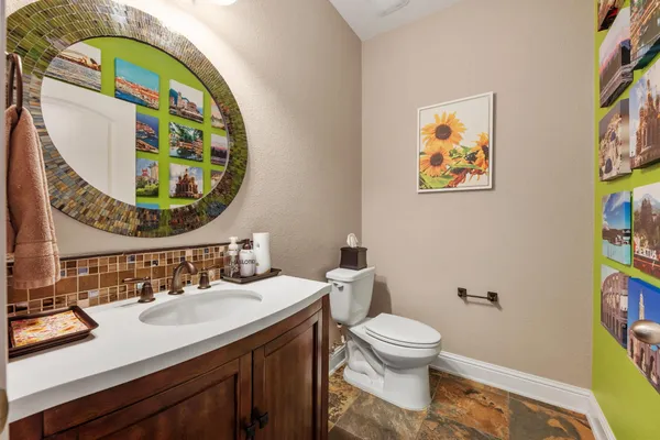 a bathroom with a toilet a sink and a mirror