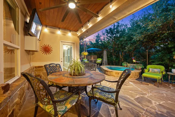a backyard of a house with garden and outdoor seating