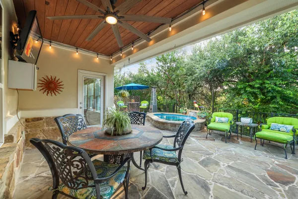 a view of an outdoor dining space with a table and chairs