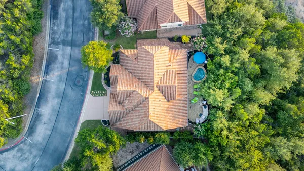 an aerial view of a house with a garden and plants