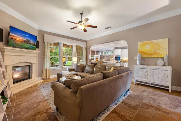 a living room with furniture a flat screen tv and a fireplace