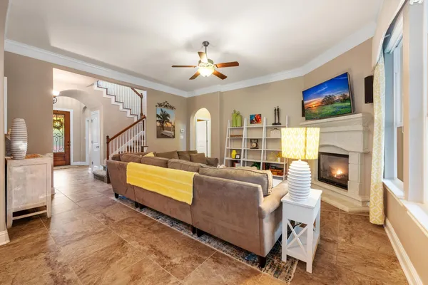 a living room with furniture a fireplace and a flat screen tv
