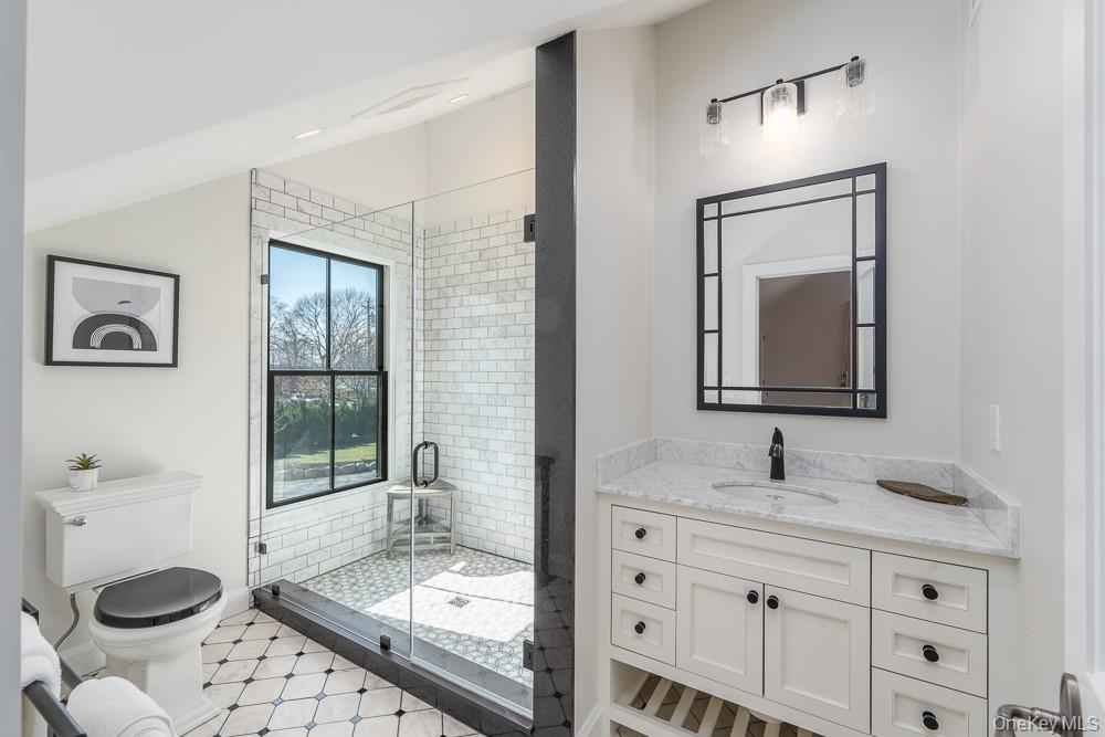 19000 Main Road Mattituck, NY 11952 - Photo 21 of 32 Full bathroom featuring a stall shower, toilet, and vanity