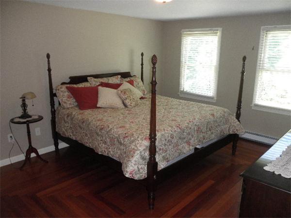 310 Wallum Lake Road Douglas, MA 01516 - Photo 11 of 19 a bed sitting in a bedroom next to a window