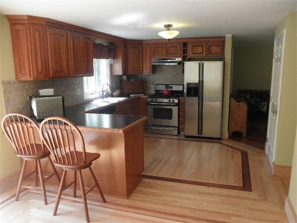 310 Wallum Lake Road Douglas, MA 01516 - Photo 4 of 19 a kitchen with stainless steel appliances granite countertop a refrigerator a stove a sink and a microwave