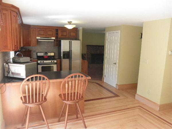 310 Wallum Lake Road Douglas, MA 01516 - Photo 7 of 19 a kitchen with stainless steel appliances kitchen island granite countertop a refrigerator a stove a microwave oven with a dining table and chairs