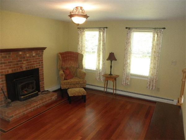 310 Wallum Lake Road Douglas, MA 01516 - Photo 8 of 19 a living room with furniture and a fireplace