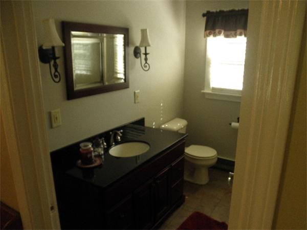 310 Wallum Lake Road Douglas, MA 01516 - Photo 10 of 19 a bathroom with a granite countertop toilet a sink and a mirror