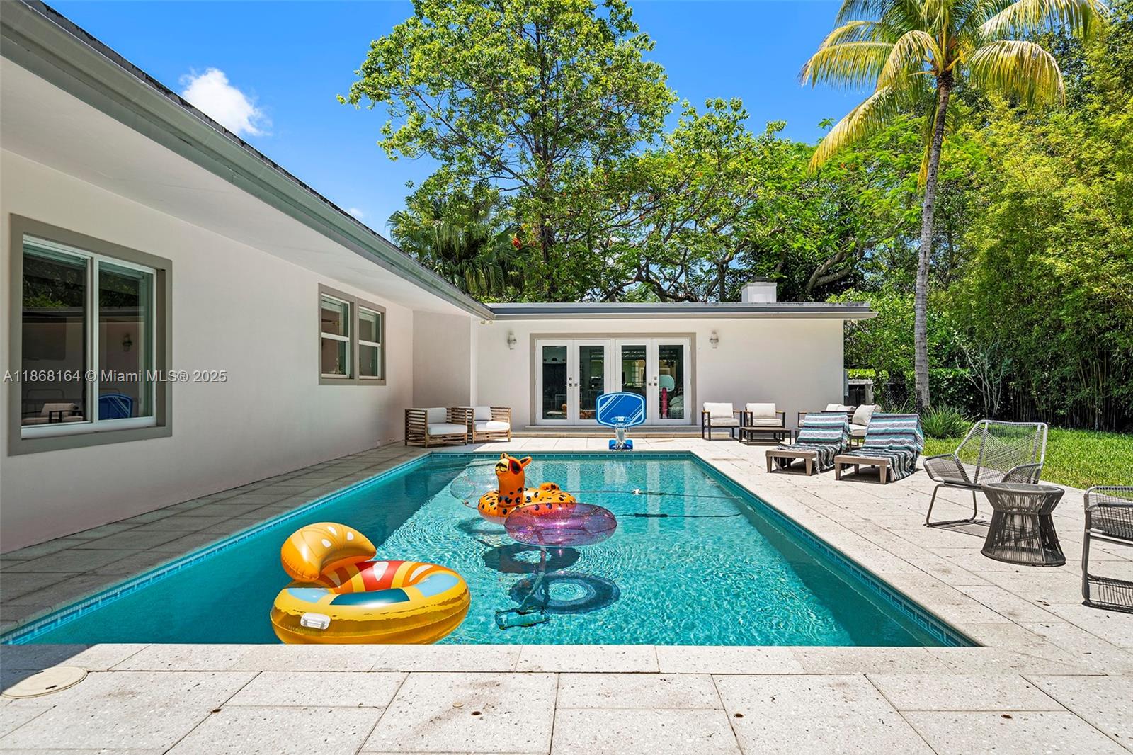 11001 Southwest 64th Avenue Pinecrest, FL 33156 - Photo 12 of 37 swimming pool view with a seating space
