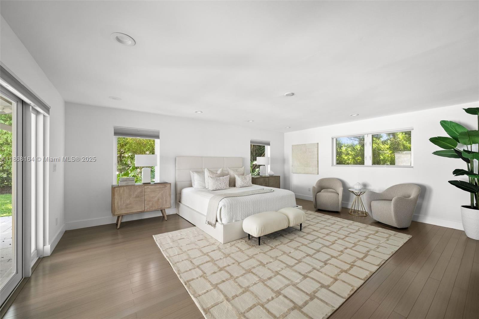 11001 Southwest 64th Avenue Pinecrest, FL 33156 - Photo 16 of 37 a spacious bedroom with a bed and glass window