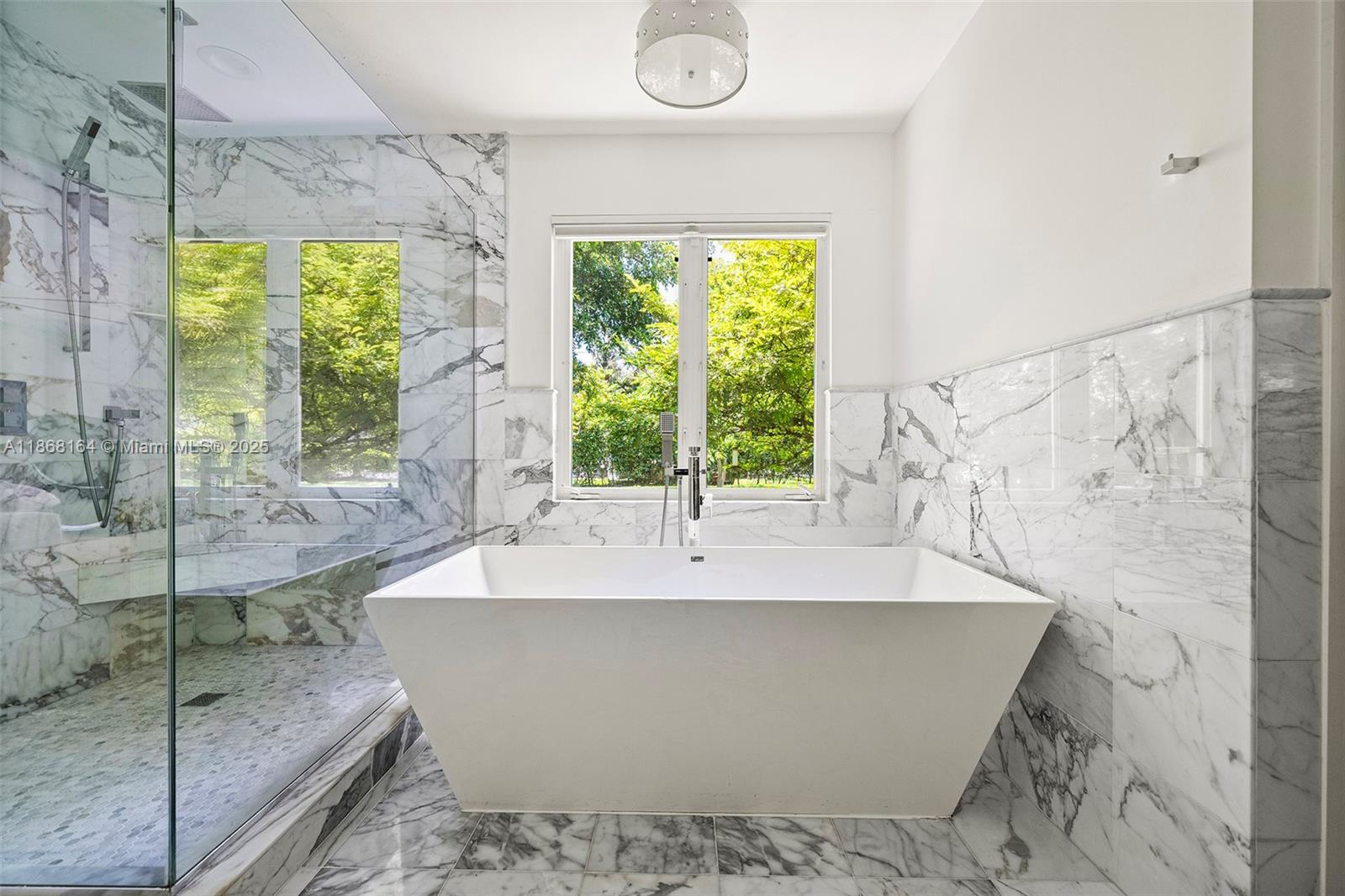 11001 Southwest 64th Avenue Pinecrest, FL 33156 - Photo 20 of 37 a white bath tub sitting in a bathroom next to a window