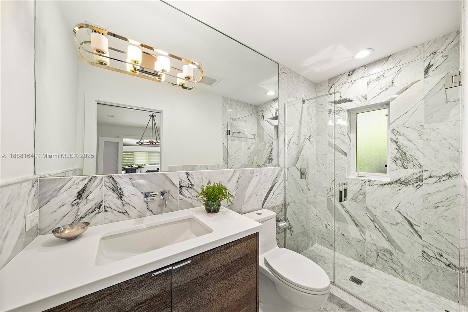 11001 Southwest 64th Avenue Pinecrest, FL 33156 - Photo 21 of 37 a bathroom with a sink a toilet and shower