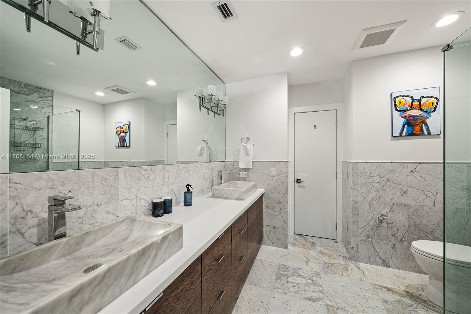 11001 Southwest 64th Avenue Pinecrest, FL 33156 - Photo 24 of 37 a spacious bathroom with double vanity sinks a mirror and a shower