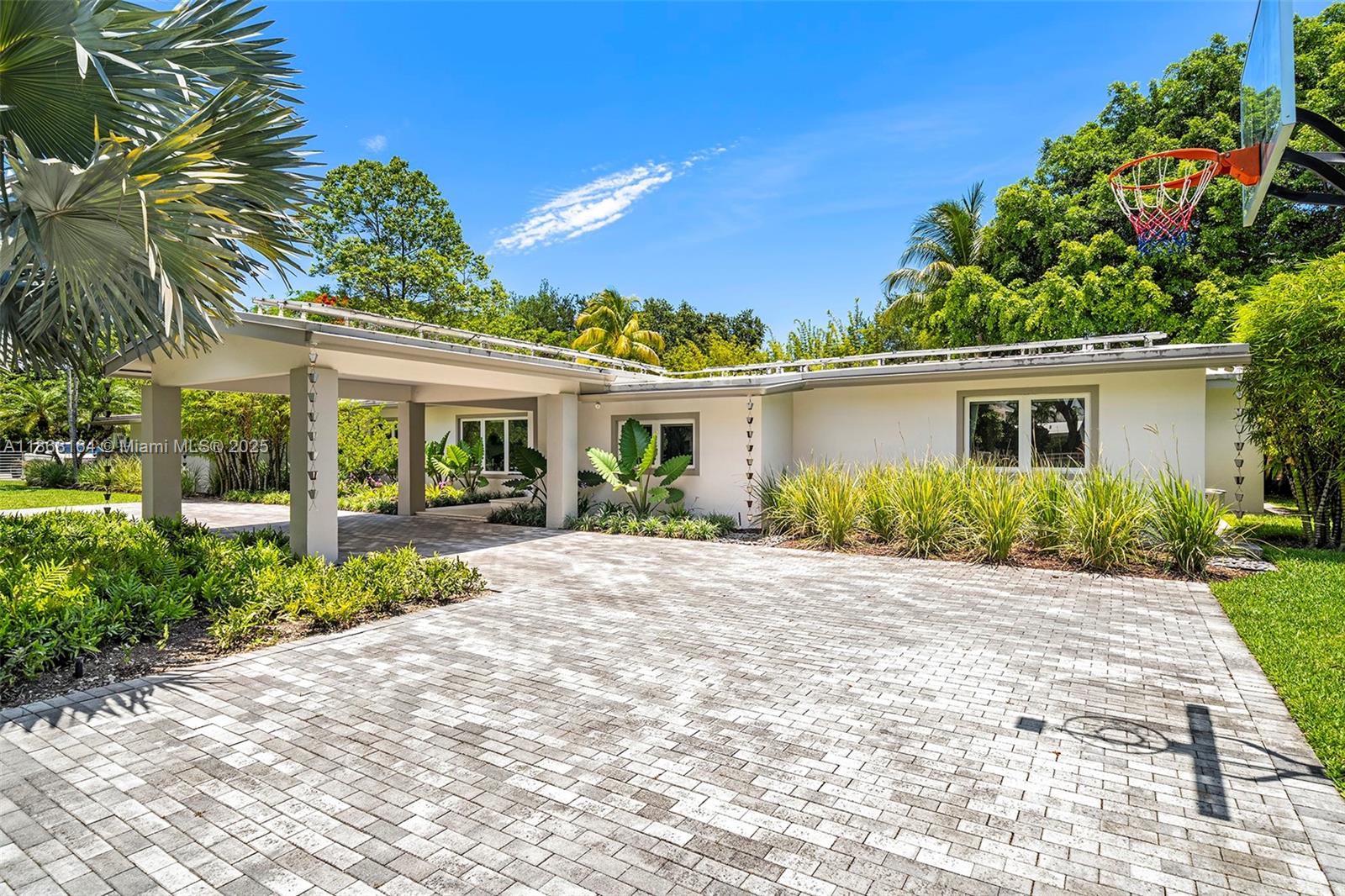11001 Southwest 64th Avenue Pinecrest, FL 33156 - Photo 28 of 37 a front view of a house with a garden