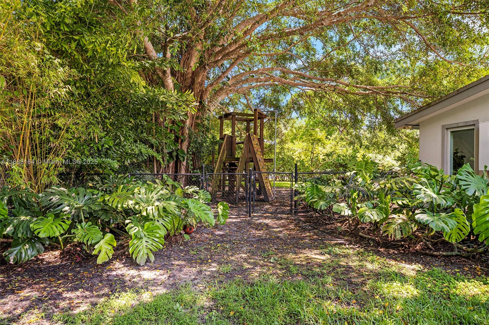 11001 Southwest 64th Avenue Pinecrest, FL 33156 - Photo 30 of 37 a backyard of a house with lots of green space