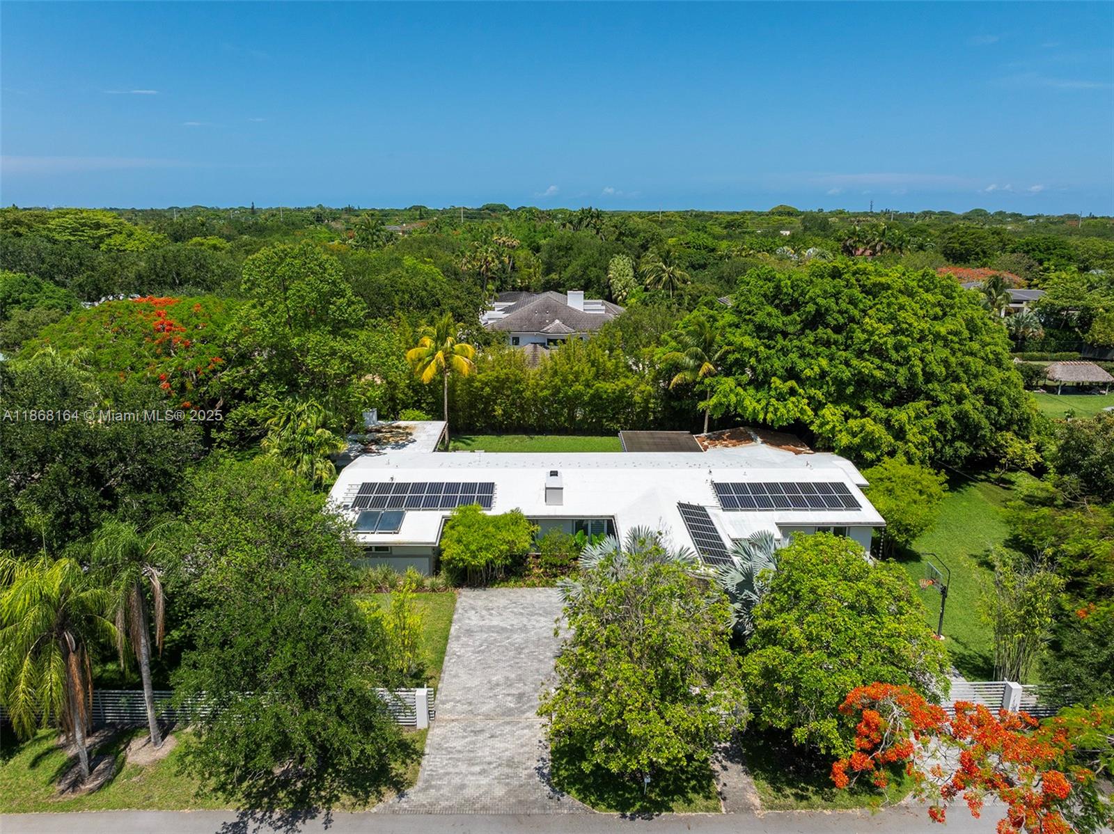 11001 Southwest 64th Avenue Pinecrest, FL 33156 - Photo 33 of 37 a view of a swimming pool with an outdoor seating and yard