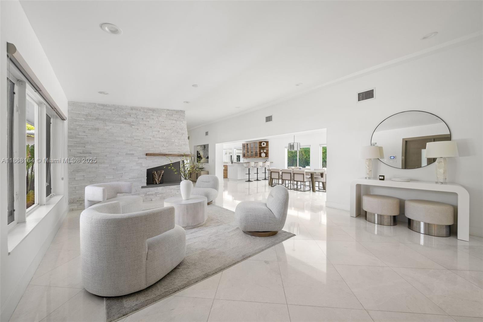 11001 Southwest 64th Avenue Pinecrest, FL 33156 - Photo 5 of 37 a living room with furniture and a fireplace