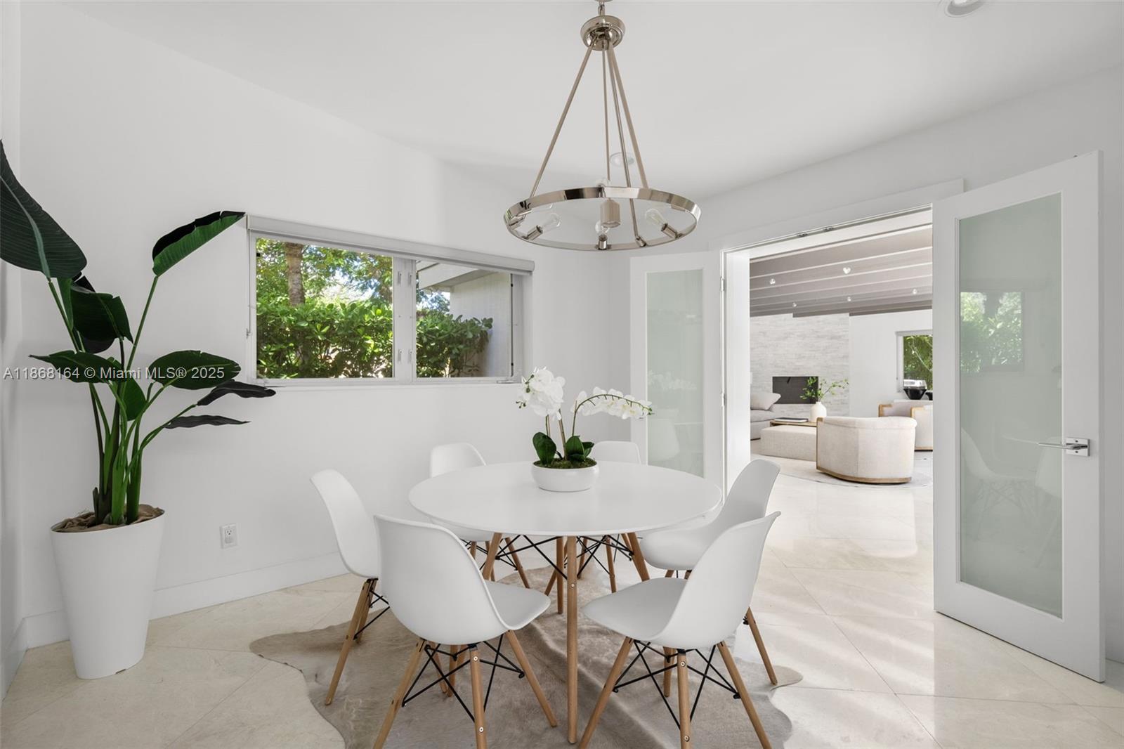 11001 Southwest 64th Avenue Pinecrest, FL 33156 - Photo 10 of 37 a view of a dining room with furniture window and outside view