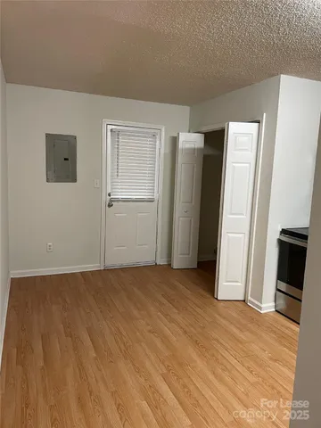 an empty room with closet and a fireplace
