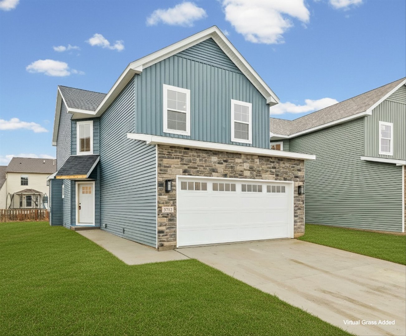 a front view of a house with a garden and yard