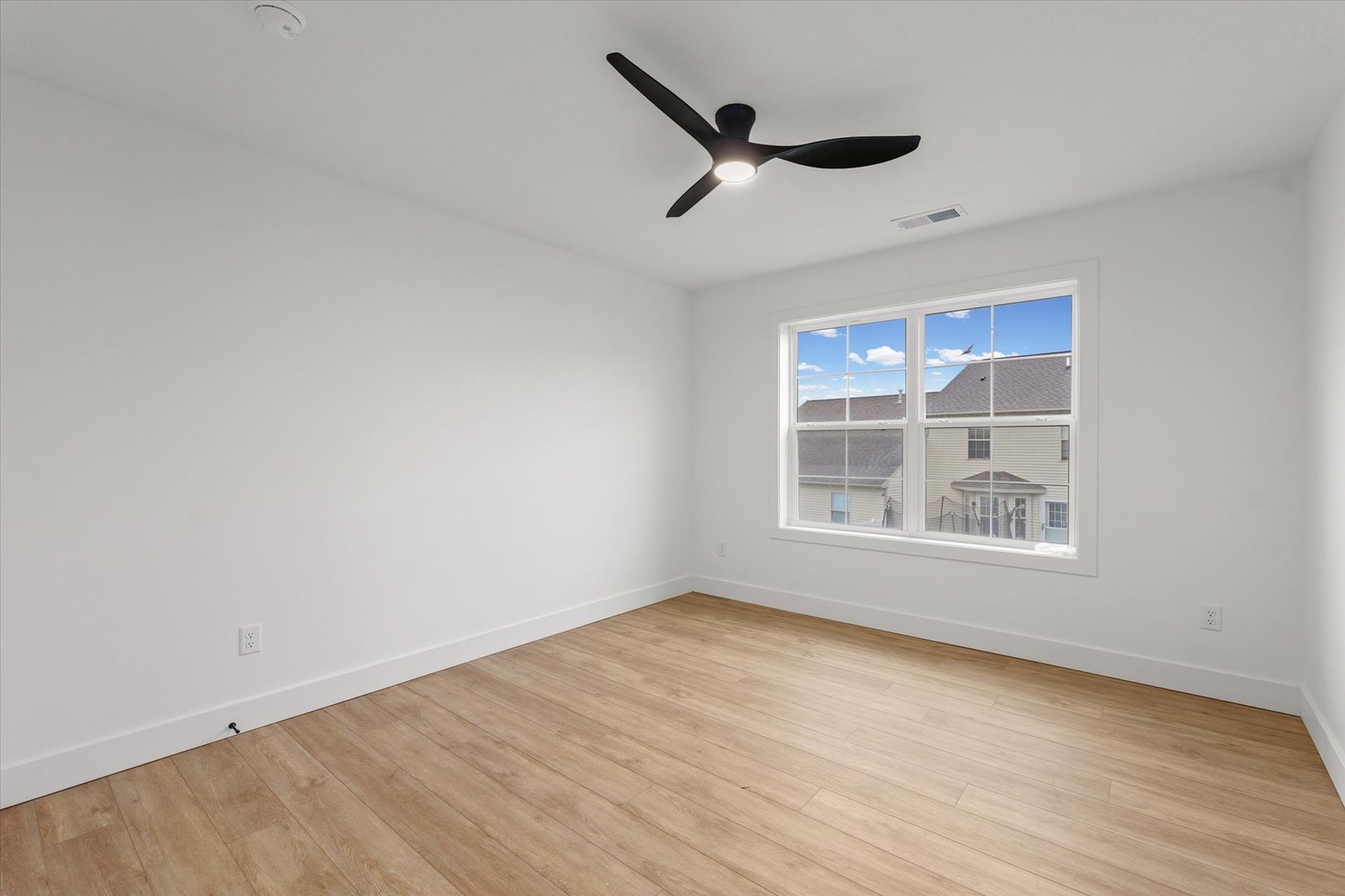 3712 Lighthouse Pointe Champaign, IL 61822 - Photo 16 of 36 an empty room with wooden floor cabinet and windows